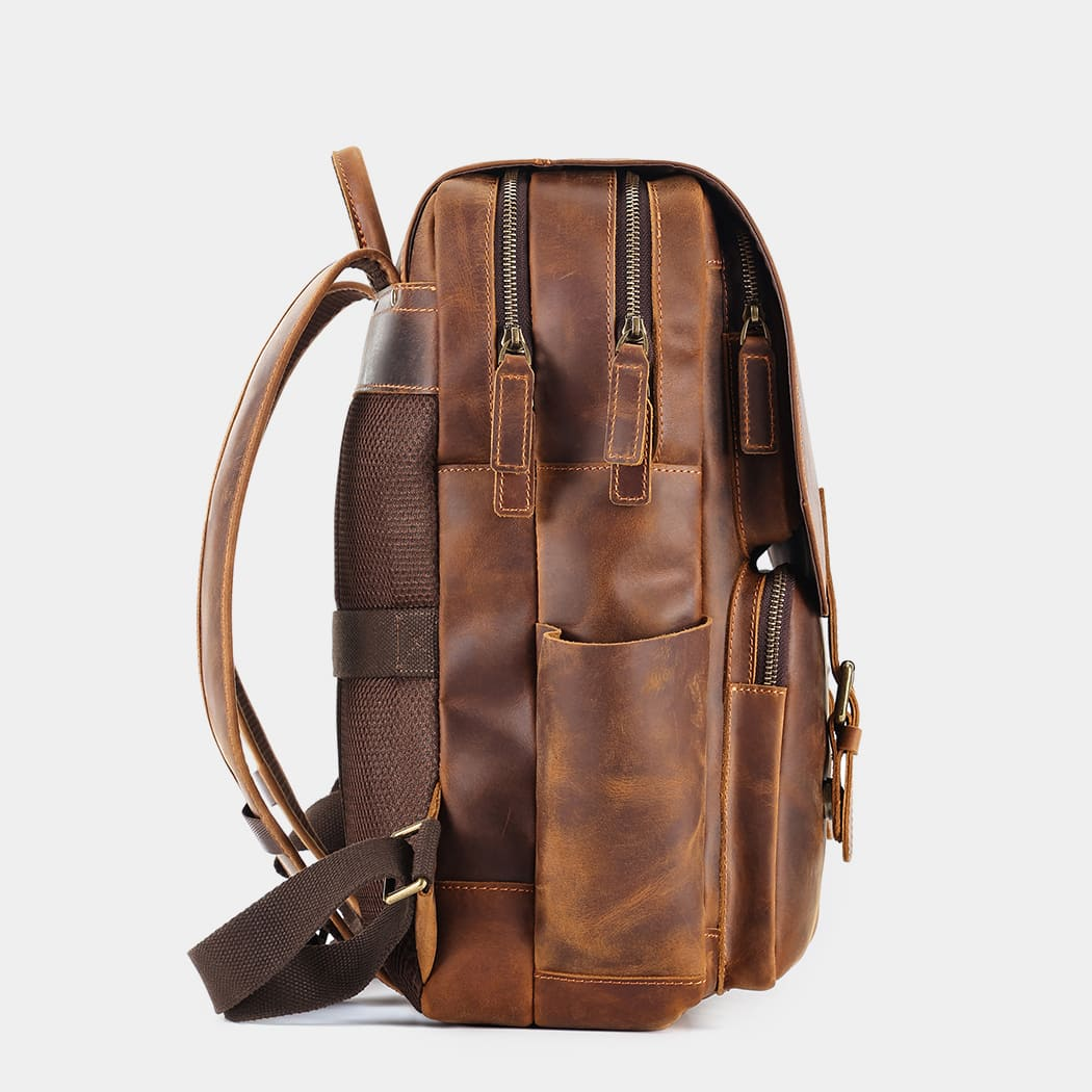 The Compact leather backpack side profile with zip pockets
