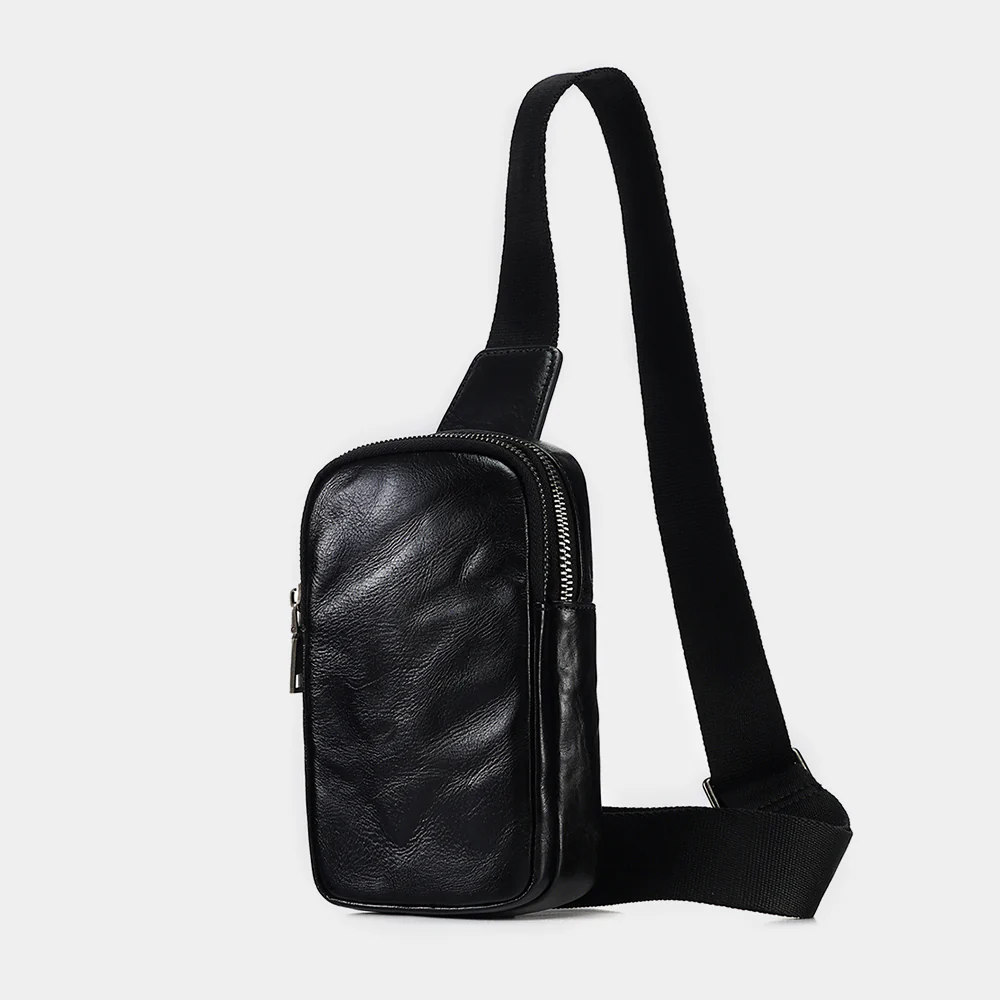 The Bellus leather sling bag, three-quarter view with strap