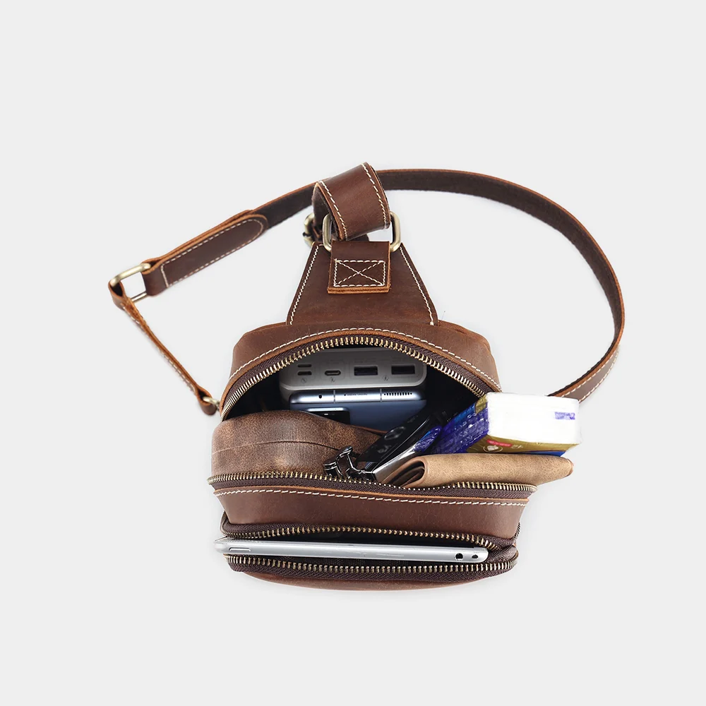The Blaze sling bag open, showing phone, cards and keys inside