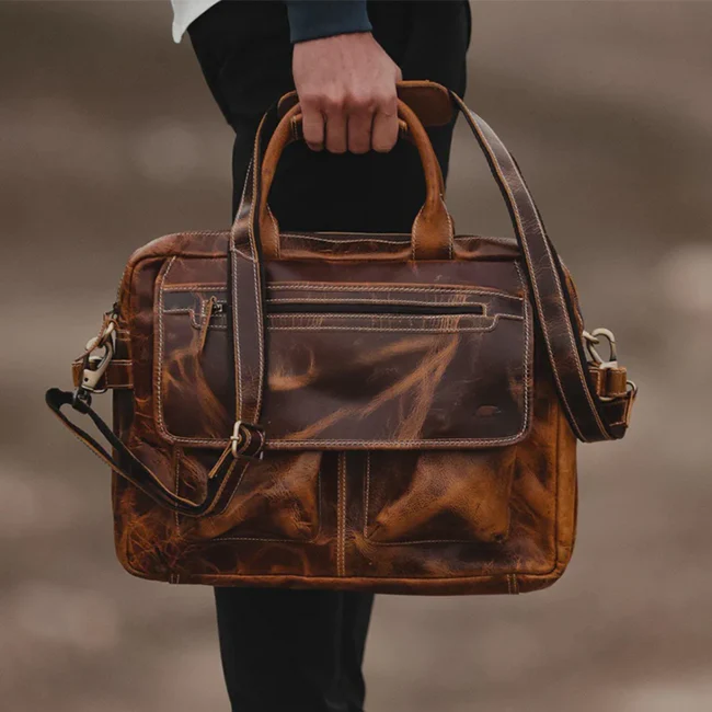 The Pilot leather briefcase carried by hand