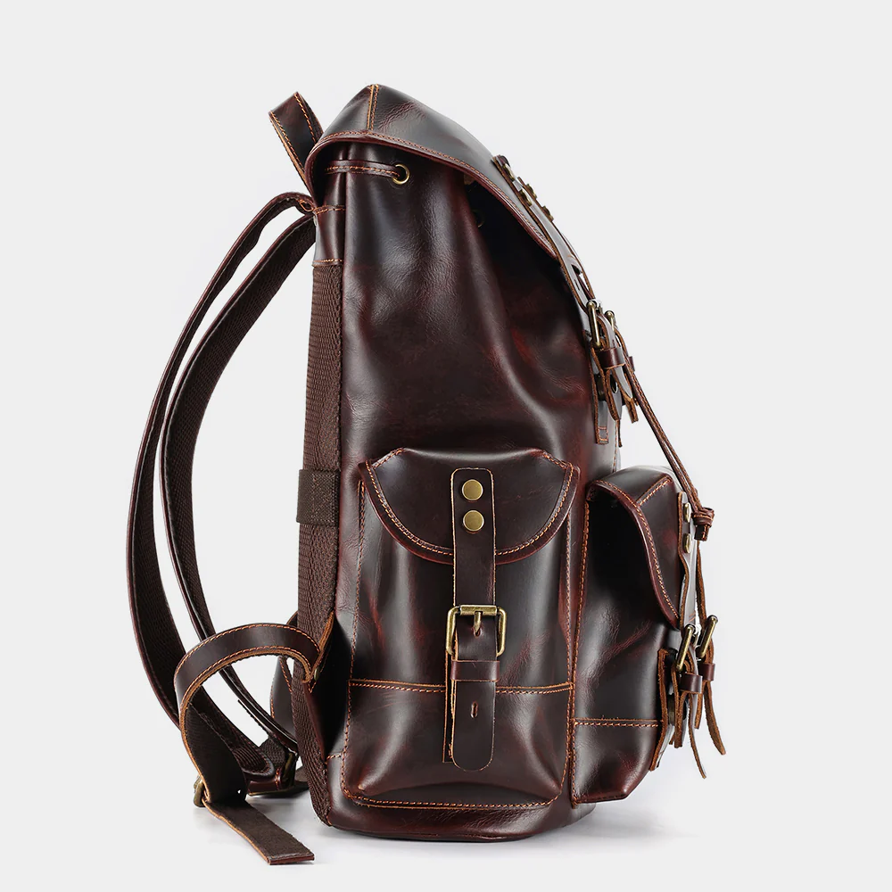 Side profile of The Wax leather backpack showing side pocket