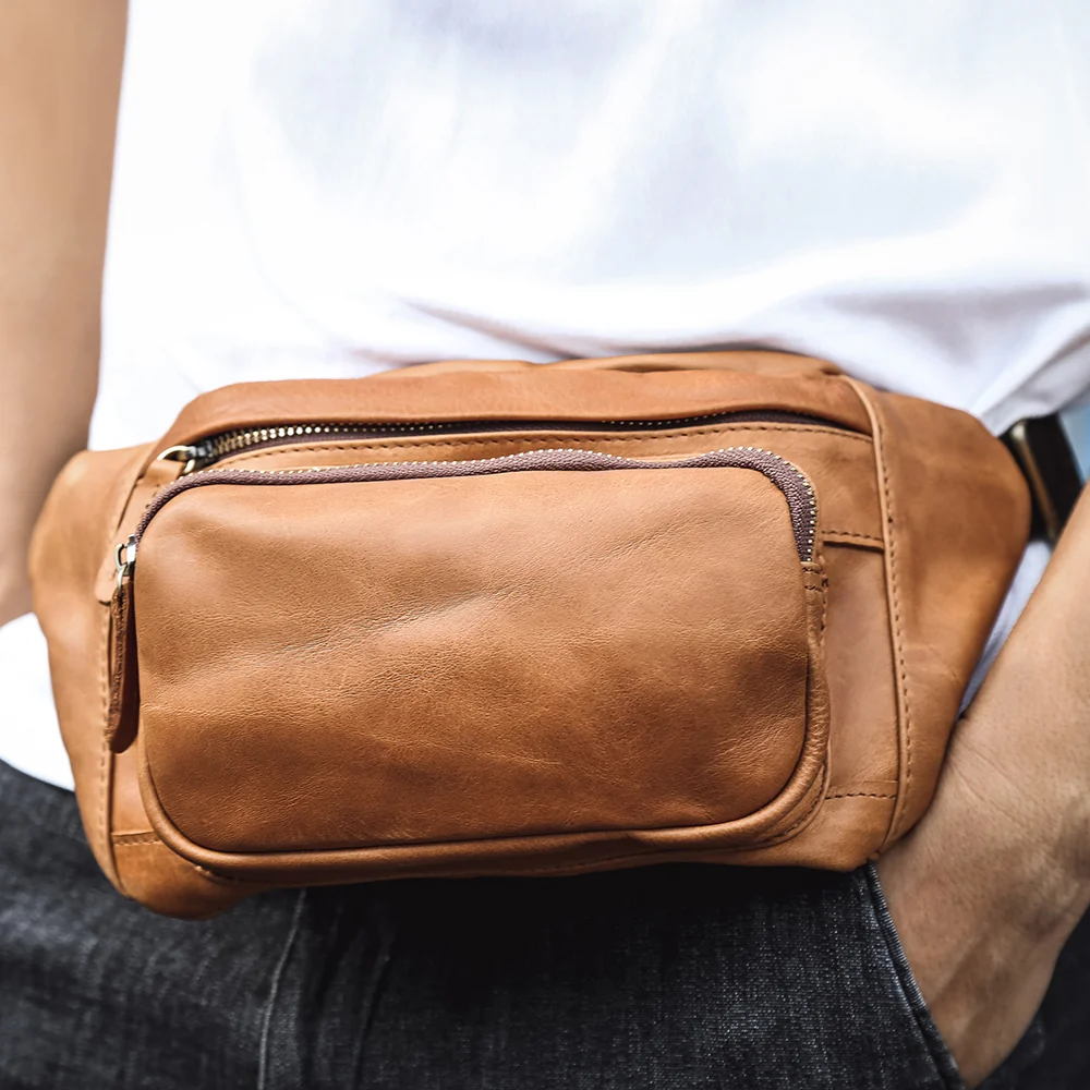 The Alpha tan leather fanny pack worn at the waist
