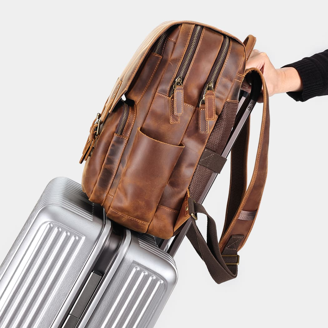 The Compact backpack sliding onto a suitcase handle