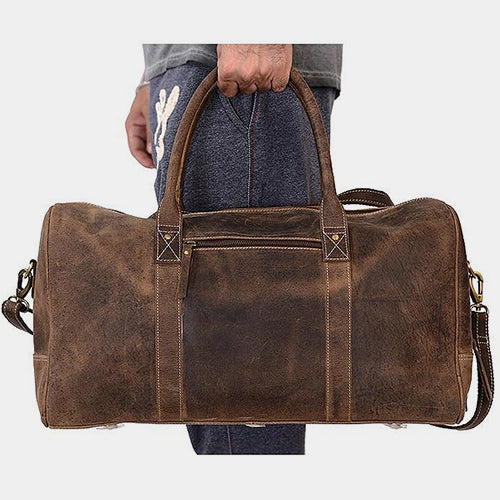 The Coarse leather duffle bag carried by the leather handles