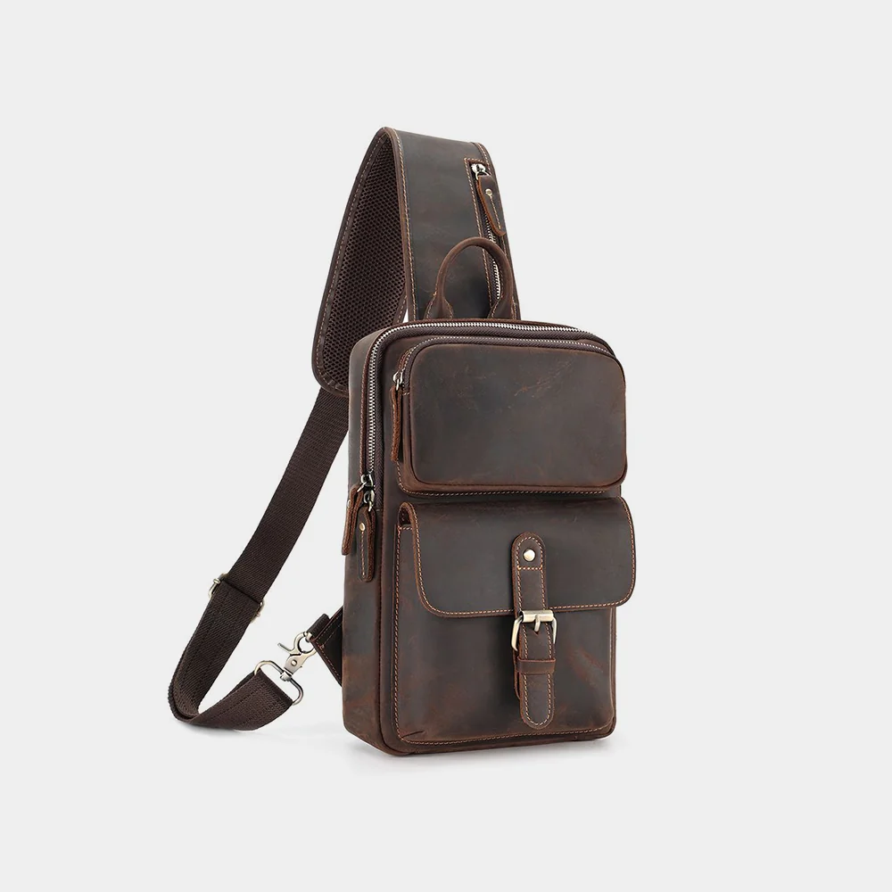 The Obrysus leather sling bag, three-quarter view with strap