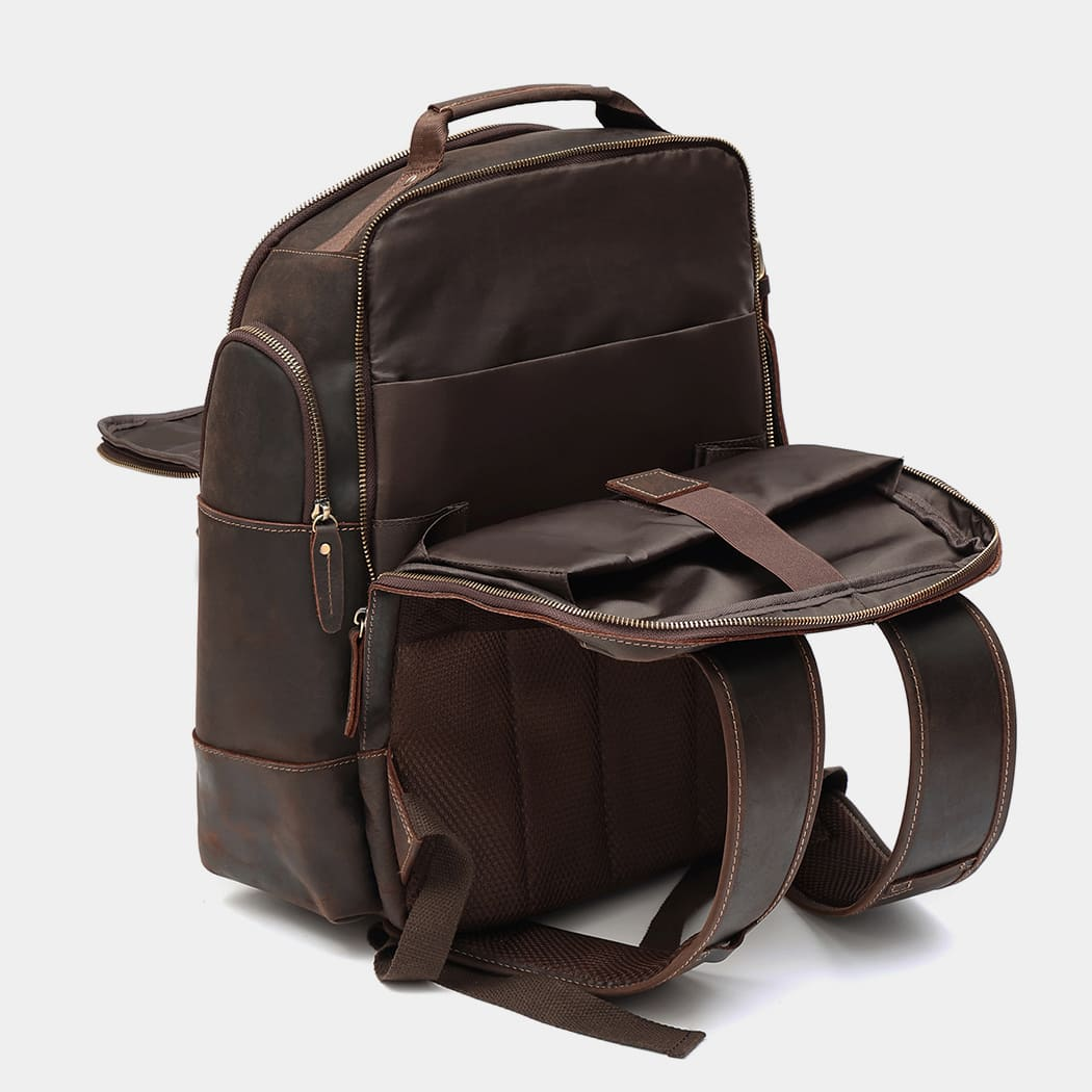 The Standard leather backpack open, showing the lined interior compartments