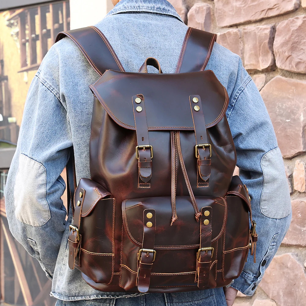 The Wax leather backpack worn over a denim jacket